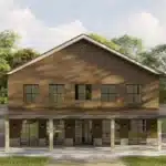 Modern barndominium in natural setting with light and dark brown colours and beautiful trees and green land around.