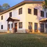 two levels white barndominium built for rural Texas