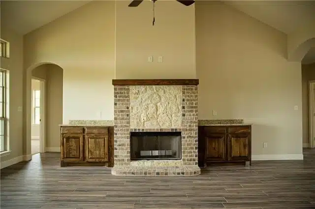 Custom barndominium living room with stone fireplace in Kerrville, Texas