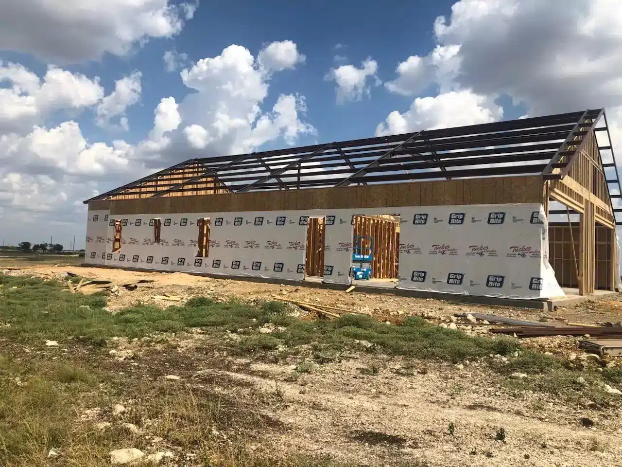 Barndominium walls wrapped in a weather-resistant barrier to help control moisture in humid East Texas conditions
