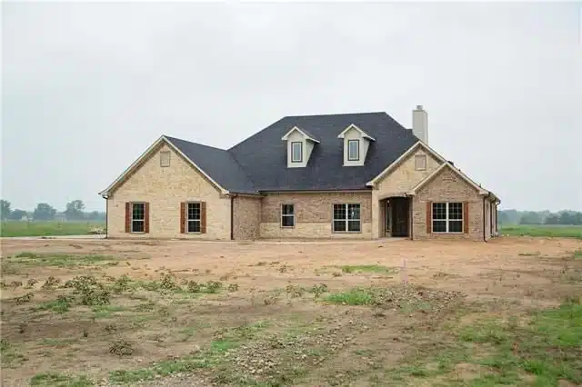 Newly built home on cleared rural land before landscaping